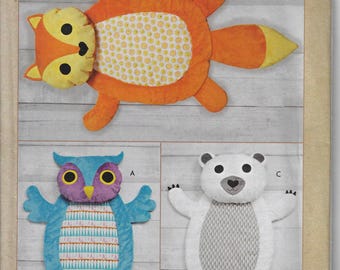 May include: Sewing pattern for three baby tummy time mats. The mats are shaped like an owl, a fox, and a polar bear. The pattern is from Kwik Sew and the pattern number is K4339.