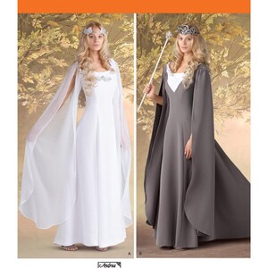 May include: Simplicity pattern 1551 features two long dresses. One is white with sheer sleeves, the other is gray with a cape. Both dresses have a square neckline and are suitable for cosplay or costume events. The pattern includes the Andrea Schewe logo.