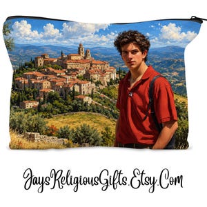 May include: A zippered pouch featuring a printed image of a person in a red polo shirt standing in front of a hillside village with stone buildings, green trees, and a blue sky with white clouds. The text JaysReligiousGifts.Etsy.Com is below.