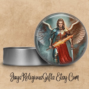 May include: A round metal tin with a lid. The lid features a colorful image of an angel warrior with wings, holding a sword and a flaming shield. The angel is wearing armor and a red cape.