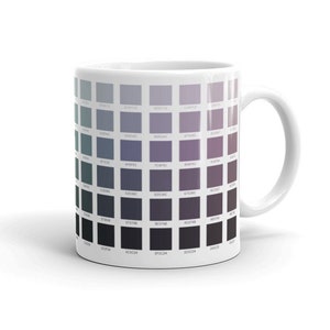May include: White ceramic mug with a color chart printed on the side. The chart features a gradient of gray, purple, and blue colors.