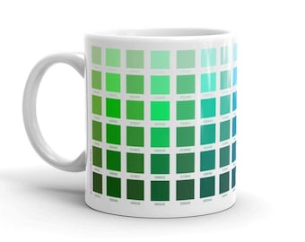 May include: White ceramic mug with a green and blue color palette printed on the side. The colors are arranged in a grid pattern, with each square representing a different shade.