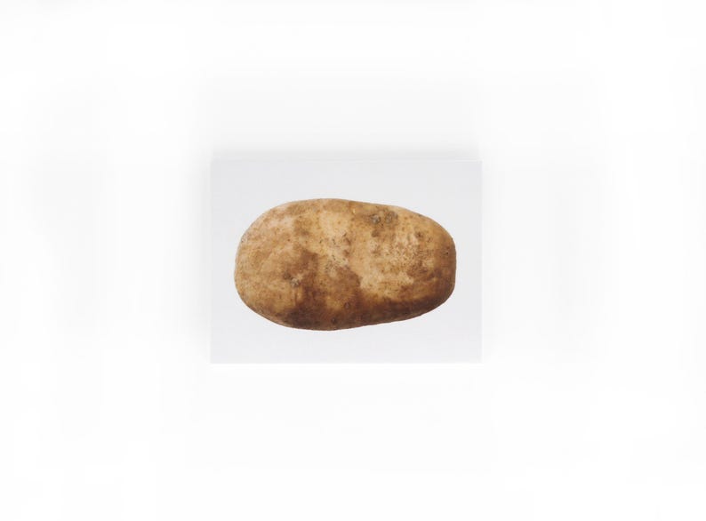 May include: A single brown potato with a rough texture.