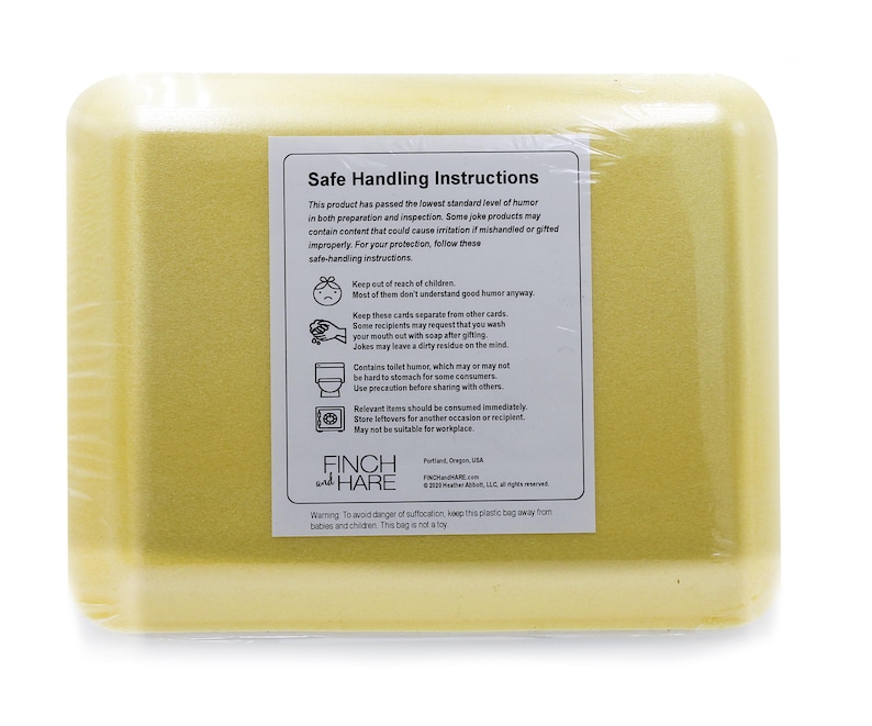 May include: Yellow foam packaging with a label that reads "Safe Handling Instructions". The label includes instructions for handling joke products, such as keeping them out of reach of children and washing your hands after handling them. The label also includes the company logo, "Finch and Hare".