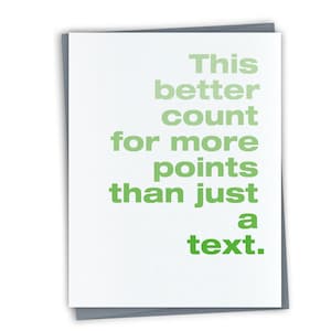 May include: A white card with green text that reads "This better count for more points than just a text."