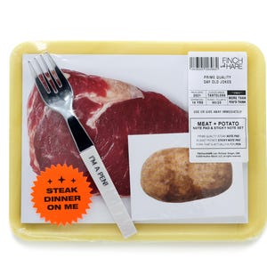 May include: A yellow plastic container with a raw steak, a potato, a fork, and a sticker that says "Steak Dinner On Me". The container also has a label that says "Finch & Hare Prime Quality Day Old Jokes".