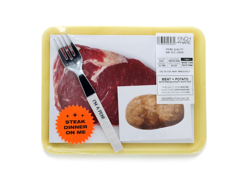 May include: A yellow plastic container with a raw steak, a potato, a fork, and a sticker that says "Steak Dinner On Me". The container also has a label that says "Finch & Hare Prime Quality Day Old Jokes".