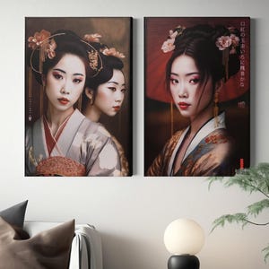 two framed artworks of women in traditional Japanese attire, hanging on a wall above a small table with a lamp and a plant.