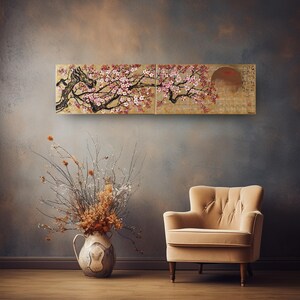 a living room with a large floral painting hanging on the wall above a beige armchair. The painting depicts a cherry blossom tree with pink flowers, creating a serene and elegant atmosphere in the room.