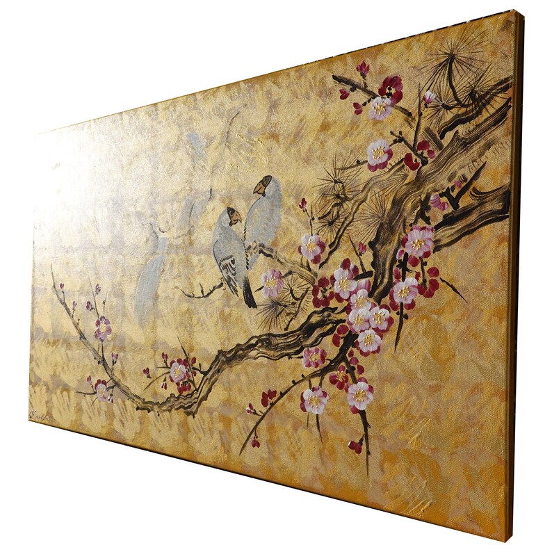 A painting of two birds perched on a branch with pink and white flowers, set against a golden background.