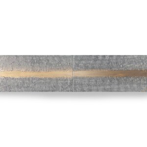 The image is a two-panel abstract artwork with a horizontal line running through the center. The line is composed of various shades of gray and gold, creating a sense of depth and movement.