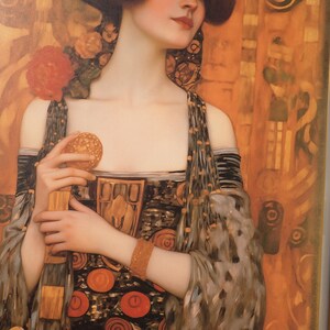 A woman with a pensive expression, wearing an ornate dress with a floral pattern, holding a small object in her hand.