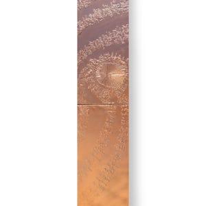 The image is a vertical panel with a textured surface, featuring a spiral pattern and a central circular design.