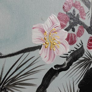 a close-up view of a pink flower with gold accents, surrounded by black and white floral elements.
