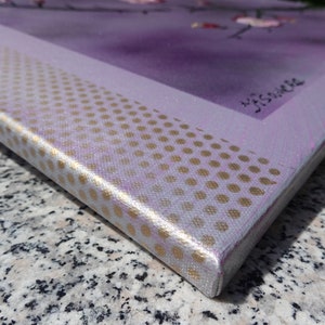 May include: Close-up of the edge of a canvas painting with a purple background and a gold polka dot pattern. The painting is signed "J.S.Vance".