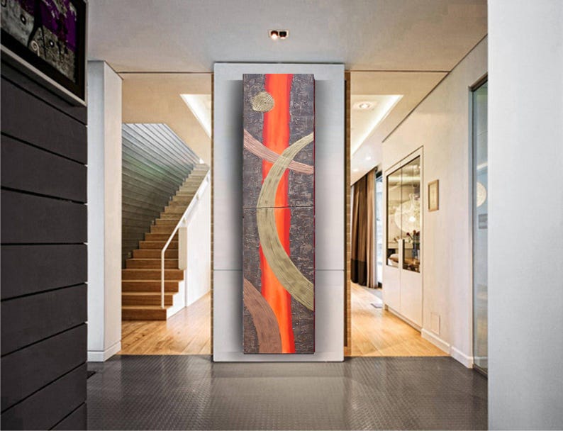 a modern hallway with a large abstract painting on the wall, a staircase, and a glass door leading to another room.