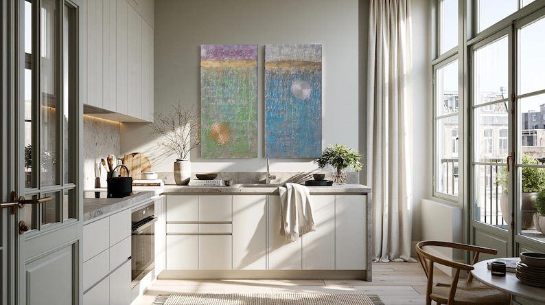 a modern, well-lit kitchen with white cabinets, a large window, and a colorful abstract painting on the wall.