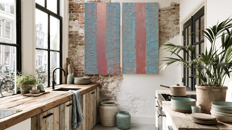 a cozy and well-decorated kitchen with a rustic wooden counter, a large window, and a colorful abstract painting on the wall.