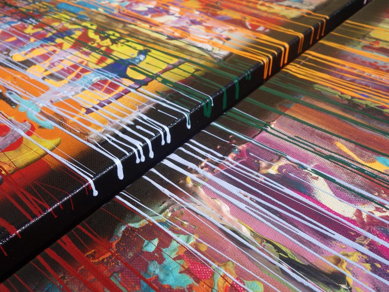 The image is a close-up of a vibrant, abstract painting with bold colors and dynamic brushstrokes. The painting features a mix of red, yellow, green, and blue hues, creating a visually striking and energetic composition.