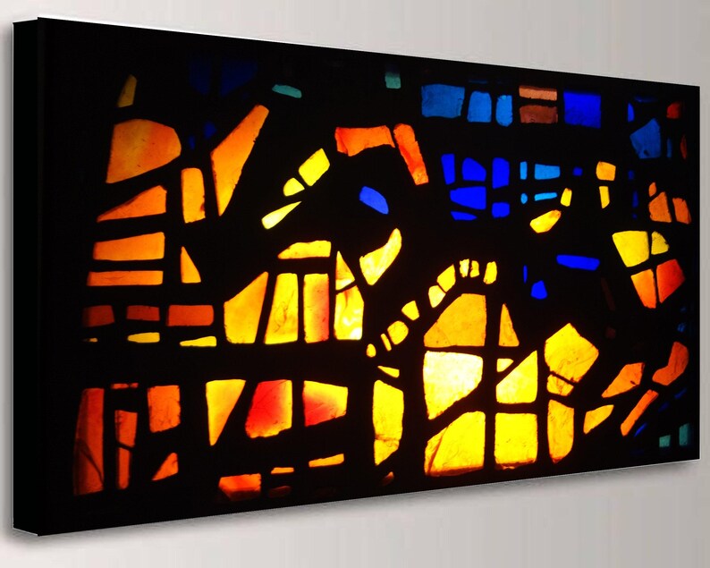 The image is a vibrant and colorful abstract artwork, featuring a variety of geometric shapes and patterns in shades of orange, yellow, blue, and black.
