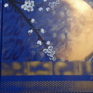 The image is a close-up of a painting featuring a branch with white flowers against a blue background, with a large golden moon in the background.