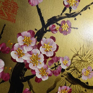 a close-up view of a painting of pink and white flowers on a gold background.