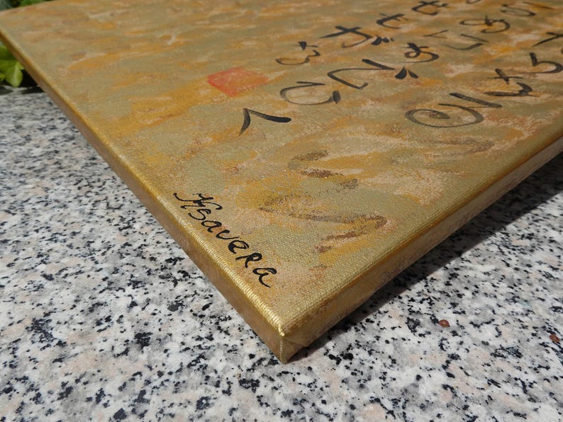 a close-up view of a textured surface, possibly a canvas or a wooden board, with some writing or markings on it.