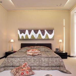 a modern bedroom with a large bed, a nightstand, and a large abstract painting on the wall.