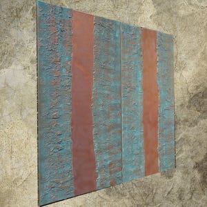 a large, rectangular piece of art with a textured, weathered appearance. The artwork has a striking contrast between the blue and orange colors, creating a visually captivating piece.