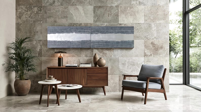 a modern living room with a large window, a wooden sideboard, a gray armchair, a wooden coffee table, and a potted plant.