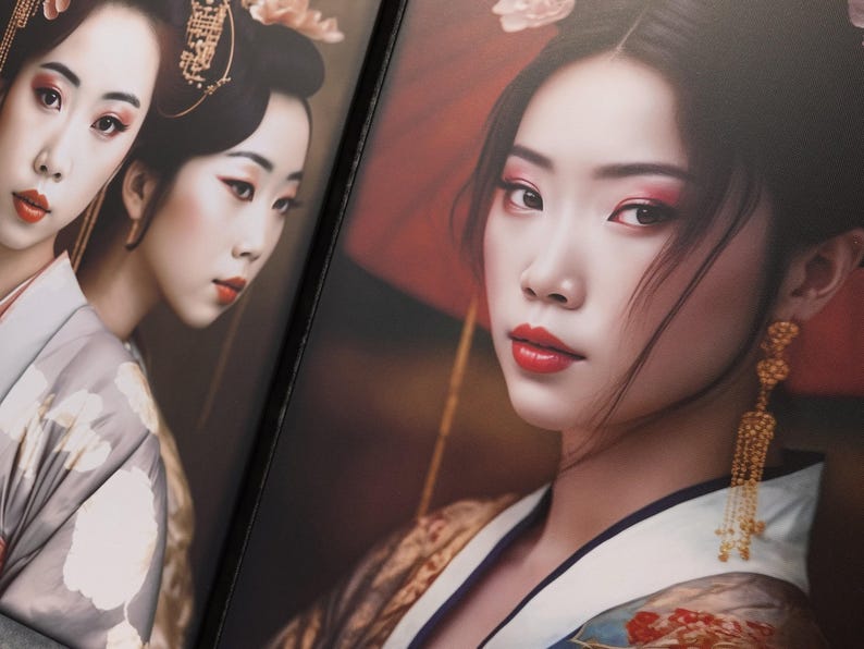 The image is a close-up of two portraits of women wearing traditional Japanese kimonos. The women have dark hair and are wearing gold earrings and red lipstick. The background is blurred, drawing attention to the women in the foreground.
