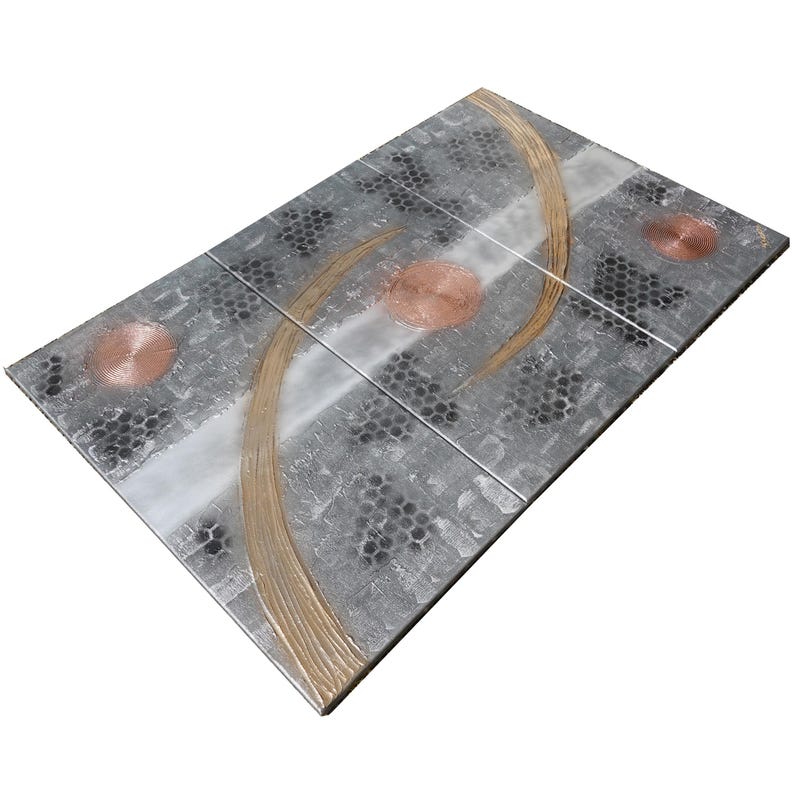 a rectangular, metallic surface with a unique design. The design consists of three distinct shapes: a circle, a curved line, and a hexagon. The circle is positioned in the top left corner, the curved line is in the middle, and the hexagon is in the top right corner. The overall design creates an interesting visual effect, with the metallic surface and the contrasting shapes creating a striking contrast.