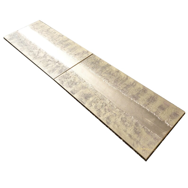a long, rectangular, metallic surface with a textured, metallic appearance.