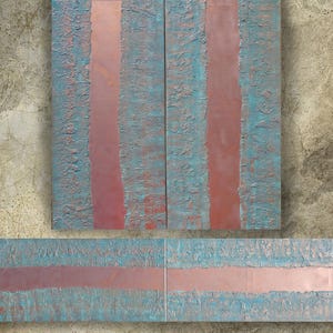 a close-up view of a textured surface with vertical lines in shades of blue and pink.