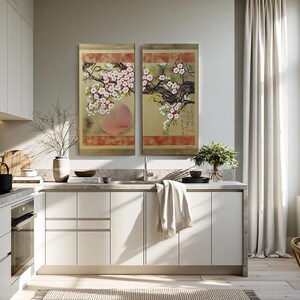 a modern, well-lit kitchen with white cabinets, a large window, and a large floral painting on the wall.