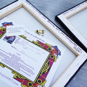 a certificate of authenticity for a painting, with a colorful frame and a gold clasp.