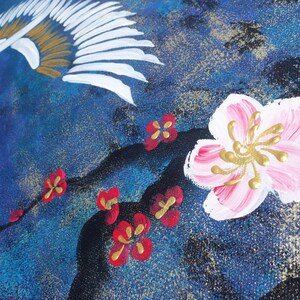The image is a close-up of a painting featuring a pink flower with gold accents, surrounded by red flowers and a bird-like design in the background.