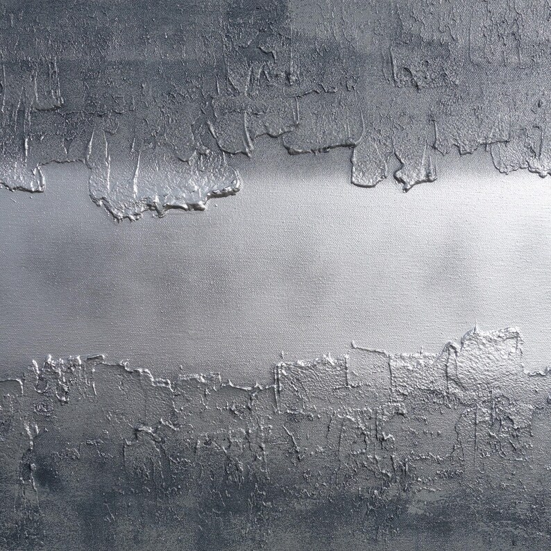 The image is a close-up of a textured surface with a metallic, metallic-looking appearance. The surface has a rough, uneven texture with a metallic sheen, giving it a metallic or metallic-like appearance.