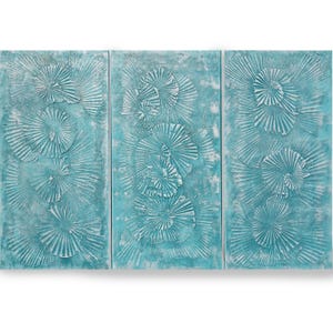 The image is a triptych of three panels, each featuring a blue and white textured background with a repeating pattern of overlapping fan-like shapes.