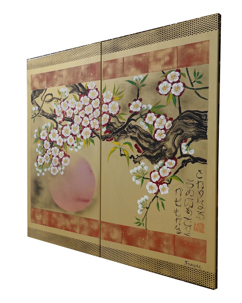 The image is a large painting depicting a branch with white flowers and a pink flower. The painting is framed with a gold border and has Japanese characters on the right side.