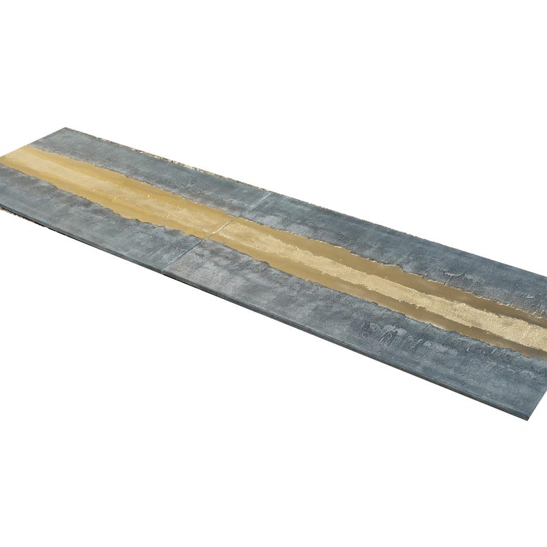 a long, narrow, and textured surface with a horizontal line running through it. The surface appears to be made of metal or a similar material, with a distinct pattern or texture.