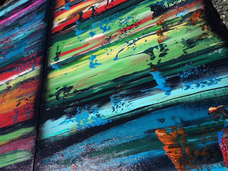 The image is a vibrant, abstract painting with bold, colorful brushstrokes and splatters of paint. The painting features a variety of colors, including red, blue, green, yellow, and orange, creating a lively and dynamic composition. The painting appears to be a large, multi-panel artwork, with the different panels overlapping each other to create a sense of depth and complexity.