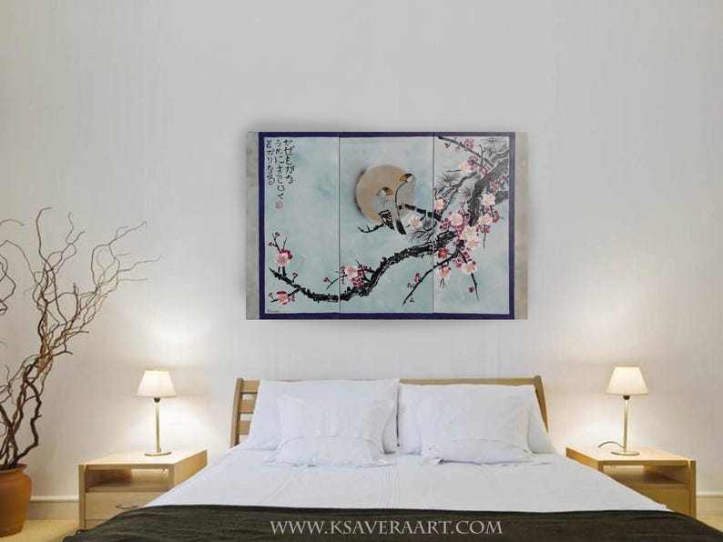 a bedroom with a large bed, two nightstands with lamps, and a painting of a bird perched on a branch with flowers on the wall above the bed.