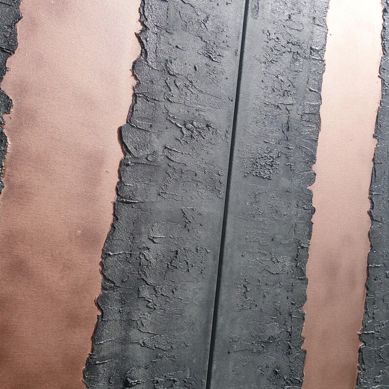 a close-up view of a textured surface with vertical lines and a metallic sheen, creating a visually striking contrast between the dark and light elements.