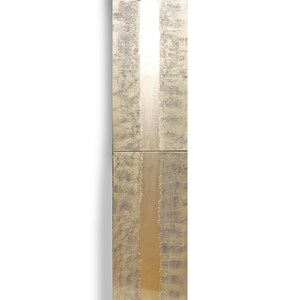 The image is a tall, narrow, and textured piece of art, possibly a painting or sculpture, with a vertical line running through it.