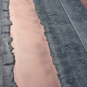 a close-up view of a textured surface with a striped pattern, featuring a mix of black and orange colors.
