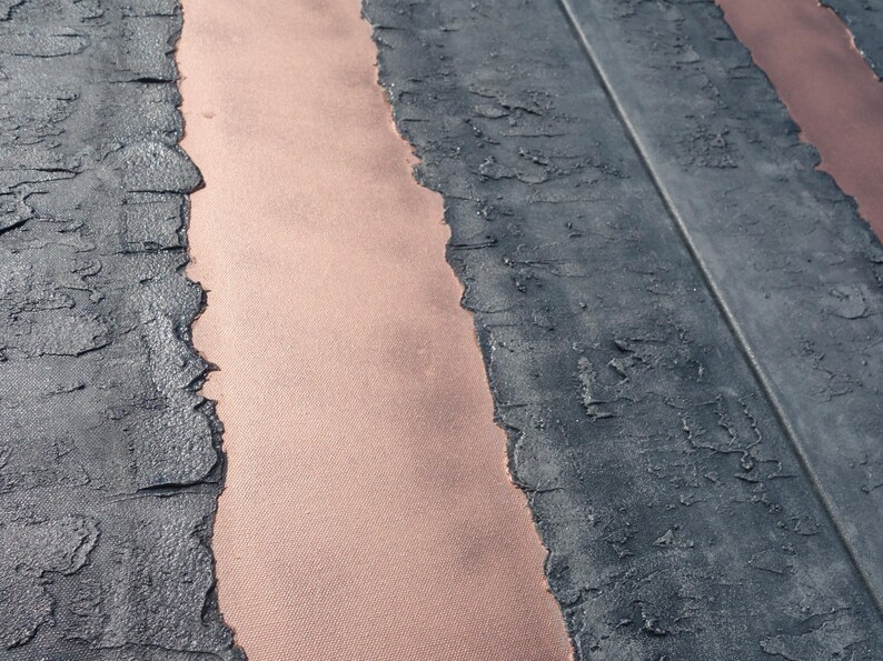 a close-up view of a textured surface with a striped pattern, featuring a mix of black and orange colors.