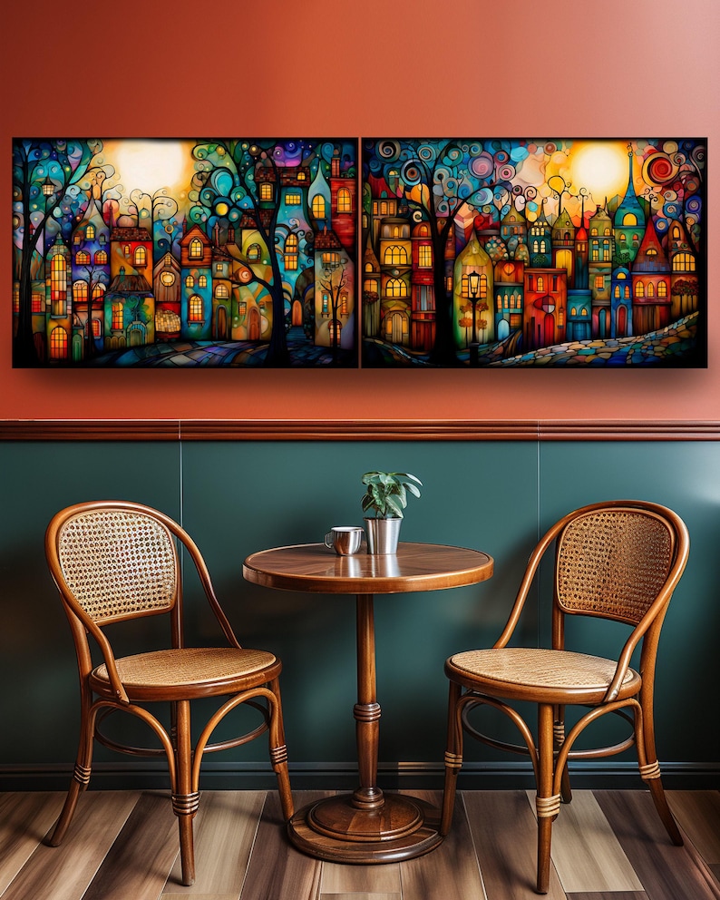 a cozy dining area with a round wooden table and two woven chairs, set against a vibrant, colorful painting of a whimsical town scene.