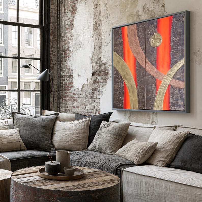 a cozy living room with a large window overlooking a cityscape. The room is furnished with a gray sofa, a wooden coffee table, and a large abstract painting on the wall.