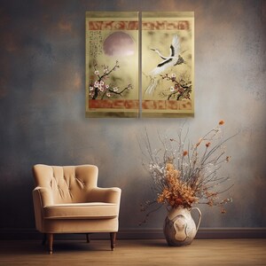 a cozy living room with a beige armchair, a vase of dried flowers, and a wall art depicting a crane and cherry blossoms.